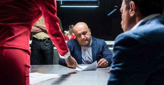 man talking to lawyers at police station